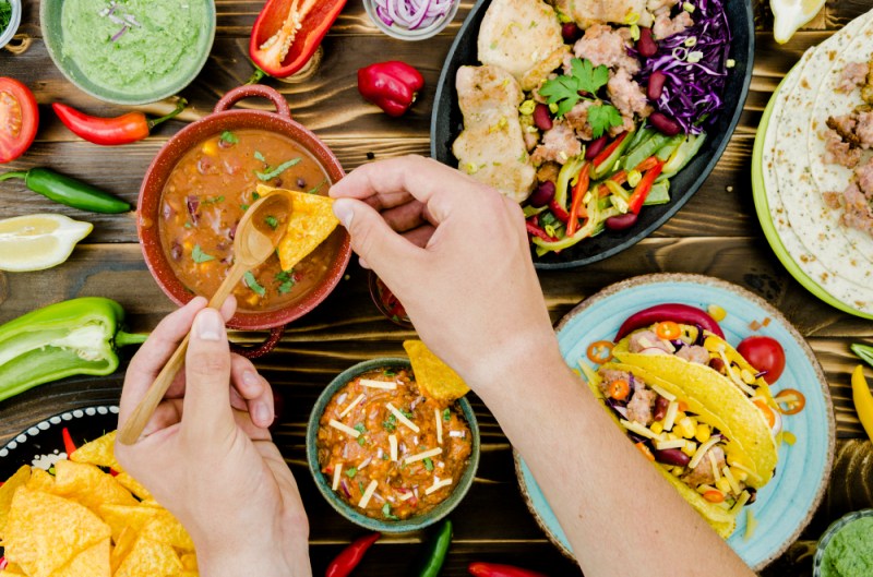 mano-sosteniendo-cuchara-nacho-comida-mexicana